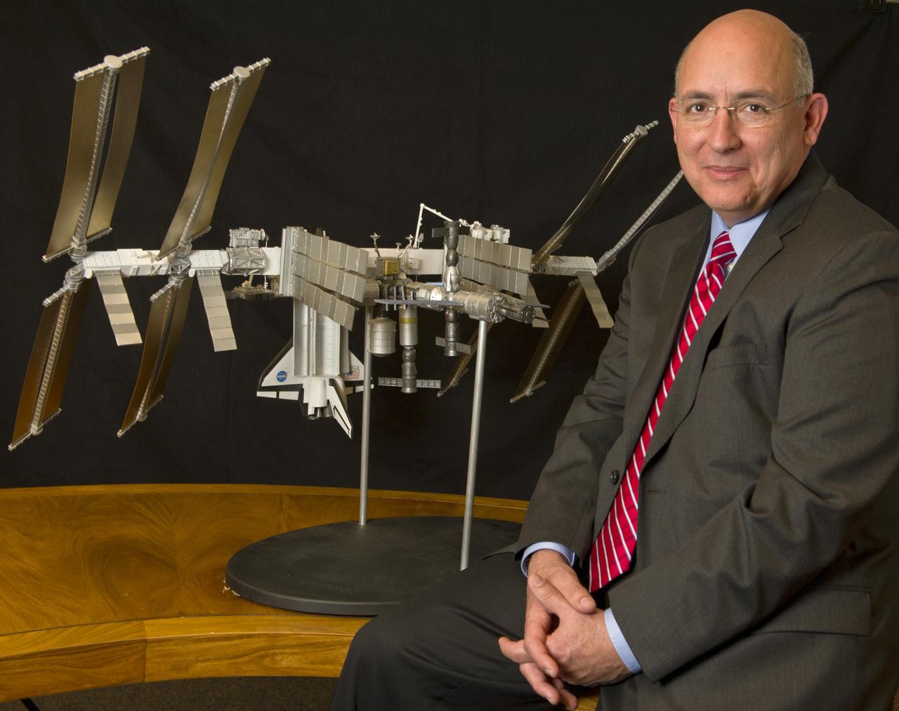 Michael Suffredini, Manager, International Space Station (ISS) Program, is seen with a scale model of the International Space Station at NASA Headquarters in Washington, Friday, Jan. 14, 2011, . Photo Credit: (NASA/Paul E. Alers)