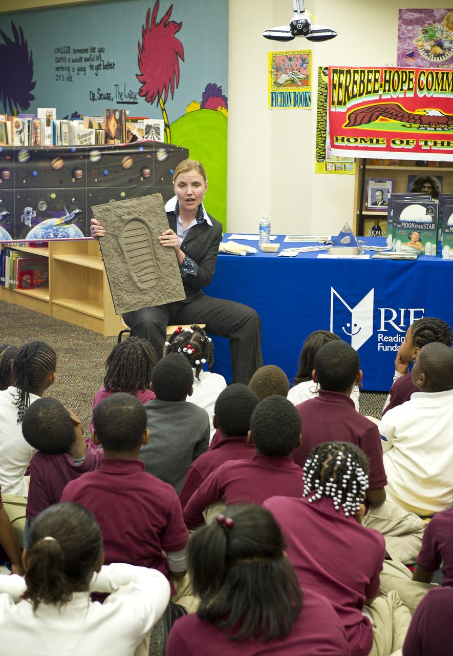 Betsy Pugel, a physicist from NASA’s Goddard Space Flight Center in Greenbelt, Md., shows students an imprint of a boot from a space suit on Tuesday, Feb. 8, 2011, at Ferebee-Hope Elementary School in Washington, DC.  Ferebee-Hope Elementary School, in collaboration with Reading is Fundamental (RIF), hosted this event in honor of Black History Month, and to highlight the importance of reading. Photo Credit: (NASA/Carla Cioffi) 