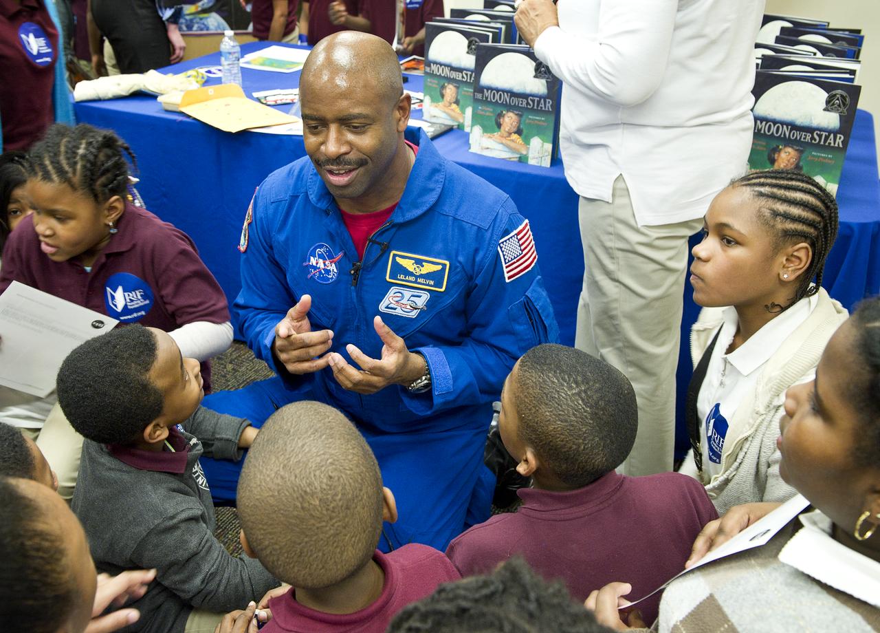 Leland Melvin, NASA Associate Administrator for Education and former space shuttle astronaut, center, speaks to students about his experience as an astronaut on Tuesday, Feb. 8, 2011, at Ferebee-Hope Elementary School in Washington, DC.  Ferebee-Hope Elementary School, in collaboration with Reading is Fundamental (RIF), hosted this event in honor of Black History Month, and to highlight the importance of reading.  Photo Credit: (NASA/Carla Cioffi)  