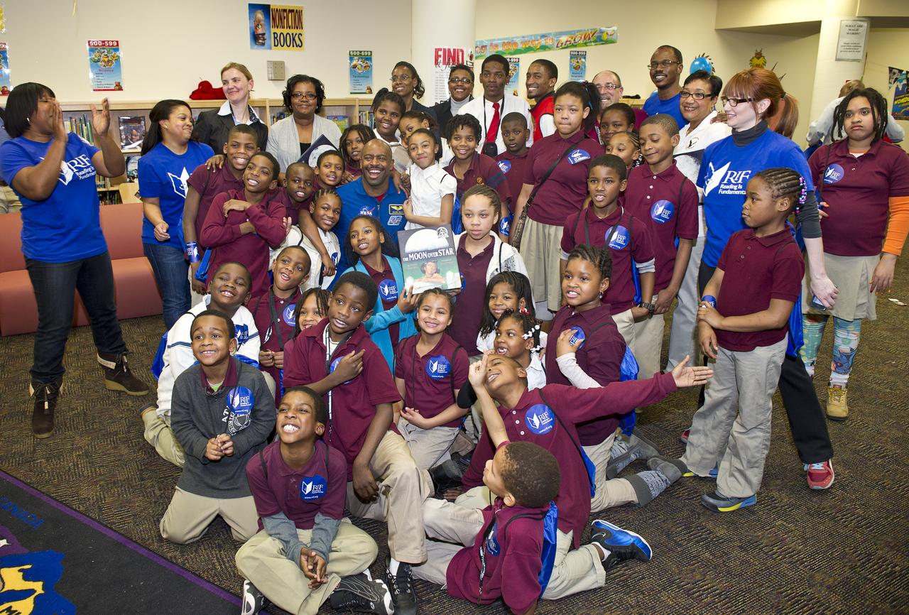 Leland Melvin, NASA Associate Administrator for Education and former space shuttle astronaut, center, poses with students from Ferebee-Hope Elementary School on Tuesday, Feb. 8, 2011 in Washington, DC. Ferebee-Hope Elementary School, in collaboration with Reading is Fundamental (RIF), hosted this event in honor of Black History Month, and to highlight the importance of reading. Photo Credit: (NASA/Carla Cioffi) 