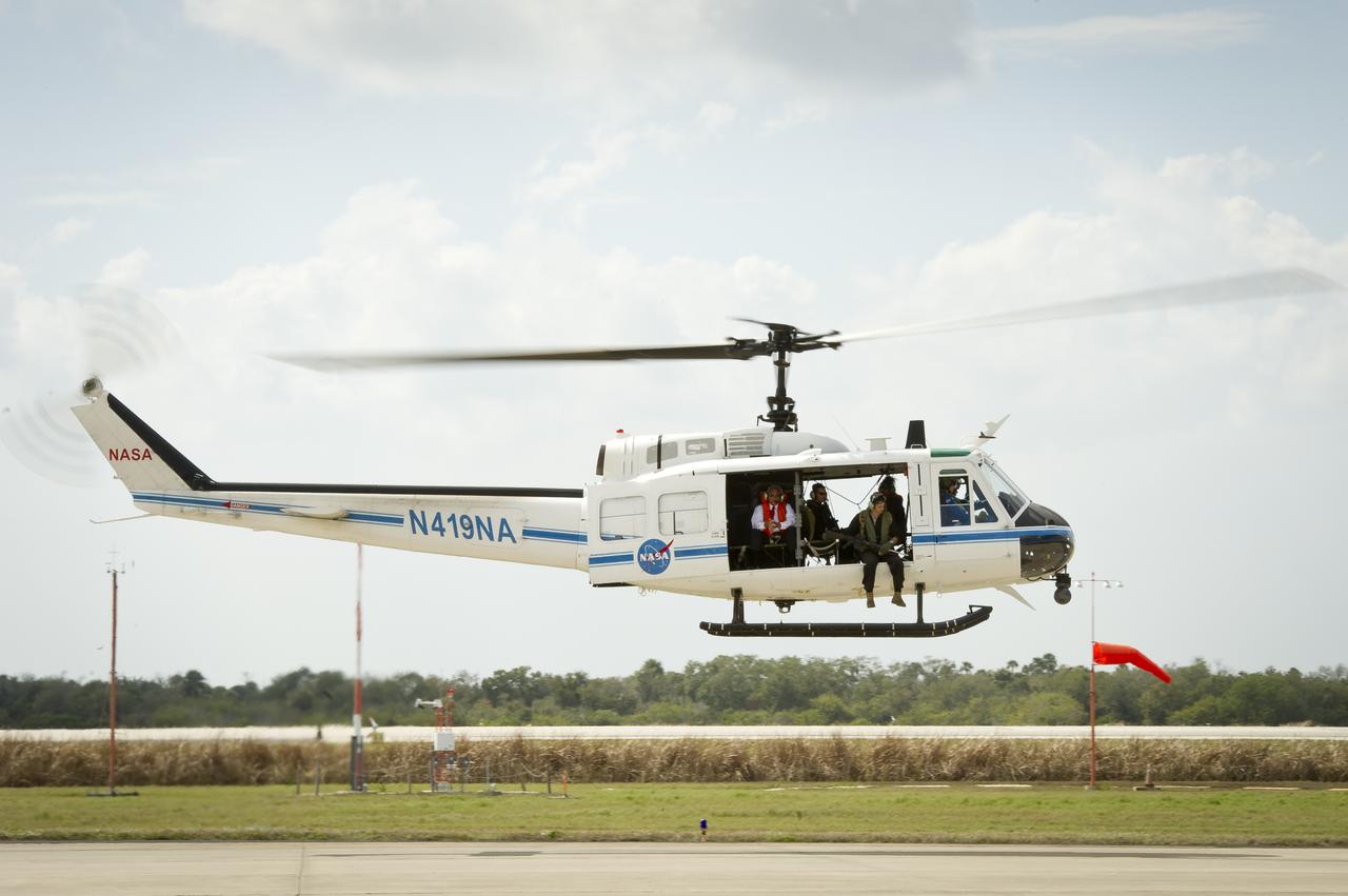 NASA Administrator Charles Bolden, seated left, takes off from the Shuttle Landing Facility (SLF) in a helicopter that will escort the crew of the space shuttle Discovery (STS-133) to launch pad 39a at the Kennedy Space Center, Thursday, Feb. 24, 2011, in Cape Canaveral, Fla. Discovery, on its 39th and final flight, is carrying the Italian-built Permanent Multipurpose Module (PMM), Express Logistics Carrier 4 (ELC4) and Robonaut 2, the first humanoid robot in space to the International Space Station. Photo Credit: (NASA/Bill Ingalls)