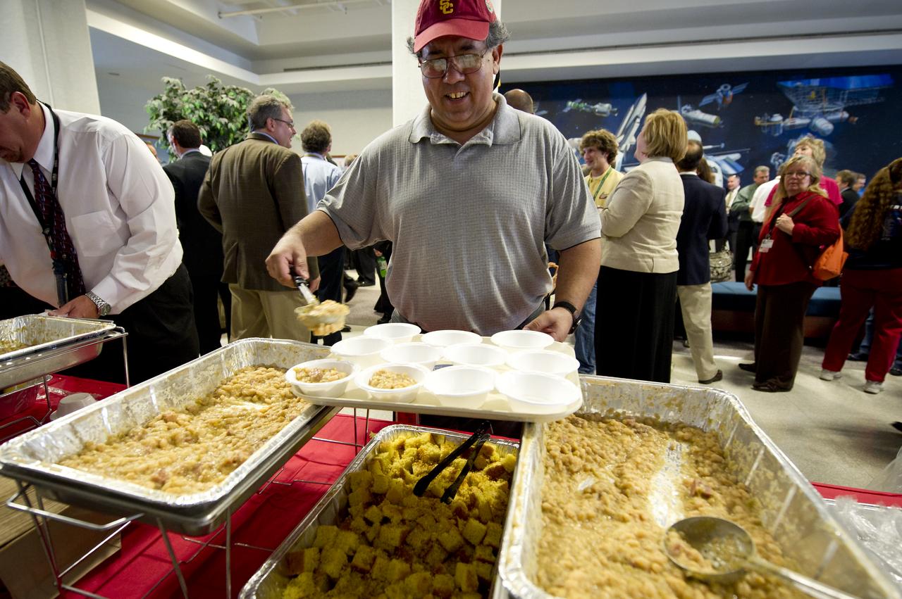 NASA Orbital Processing Facility Inspector Janaro Negrete, fills cups with the post launch traditional beans and cornbread to take share with his colleagues at the Launch Control Center (LCC) after the launch of the space shuttle Discovery (STS-133) at the Kennedy Space Center, Thursday, Feb. 24, 2011, in Cape Canaveral, Fla. Discovery, on its 39th and final flight, is carrying the Italian-built Permanent Multipurpose Module (PMM), Express Logistics Carrier 4 (ELC4) and Robonaut 2, the first humanoid robot in space to the International Space Station. Photo Credit: (NASA/Bill Ingalls)