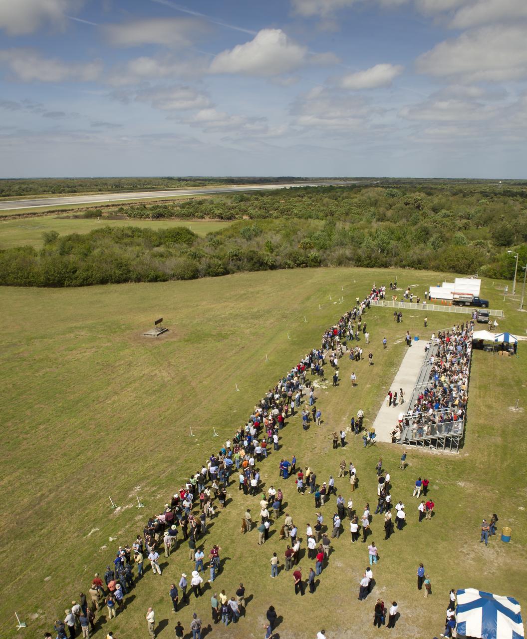 Crowds start to gather at the Shuttle Landing Facility (SLF) in preparation for the landing of the space shuttle Discovery, Wednesday, March 9, 2011, at Kennedy Space Center in Cape Canaveral, Fla.  This was Discovery's final flight.  Discovery flew 39 missions, spent 365 days in space, orbited Earth 5,830 times and traveled 148,221,675 miles.  Photo credit: (NASA/Bill Ingalls)