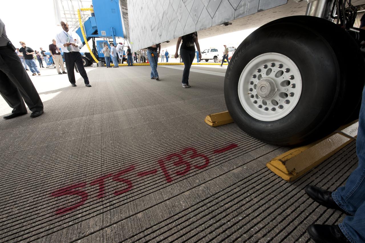 The runway of the Shuttle Landing Facility (SLF) is marked to show where the wheels stopped for the space shuttle Discovery (STS-133) shortly after it landed, Wednesday, March 9, 2011, at Kennedy Space Center in Cape Canaveral, Fla., completing its 39th and final flight.  Since 1984, Discovery flew 39 missions, spent 365 days in space, orbited Earth 5,830 times and traveled 148,221,675 miles.  Photo credit: (NASA/Bill Ingalls)