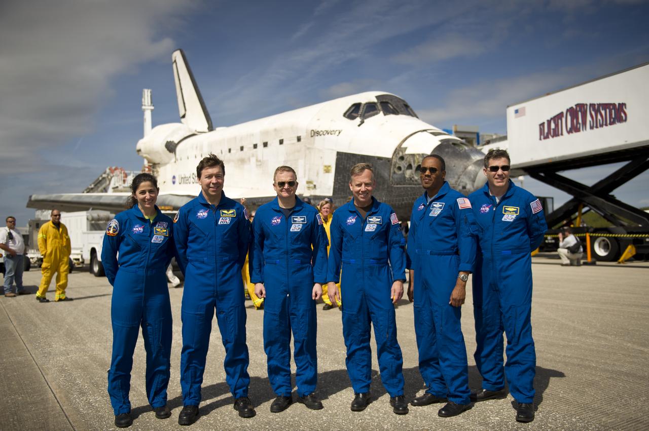 NASA Astronauts and STS-133 mission crew members, from left, Mission Specialists Nicole Stott, Michael Barratt, Pilot Eric Boe, Commander Steve Lindsey, Mission Specialists Alvin Drew, and Steve Bowen pose for a photograph in front of the space shuttle Discovery after they landed, Wednesday, March 9, 2011, at Kennedy Space Center in Cape Canaveral, Fla., completing Discovery's 39th and final flight. Since 1984, Discovery flew 39 missions, spent 365 days in space, orbited Earth 5,830 times and traveled 148,221,675 miles. Photo credit: (NASA/Bill Ingalls)