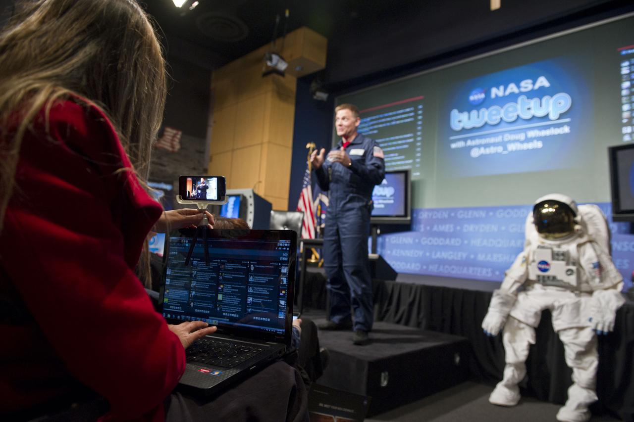 A tweetuup participant videotapes with her iPhone and tweets as astronaut Doug Wheelock discusses his experiences while living on the International Space Station during a tweetup at NASA Headquarters in Washington, Wednesday, March 16, 2011. Wheelock, who has accumulated a total of 178 days in space, assumed command of the International Space Station and the Expedition 25 crew. During Expedition 25, there were more than 120 microgravity experiments in human research; biology and biotechnology; physical and materials sciences; technology development; and Earth and space sciences. Wheelock also responded to an emergency shutdown of half of the station's external cooling system and supported three unplanned spacewalks to replace the faulty pump module that caused the shutdown. His efforts restored the station's critical cooling system to full function. The mission duration was 163 days. Photo Credit: (NASA/Paul E. Alers)