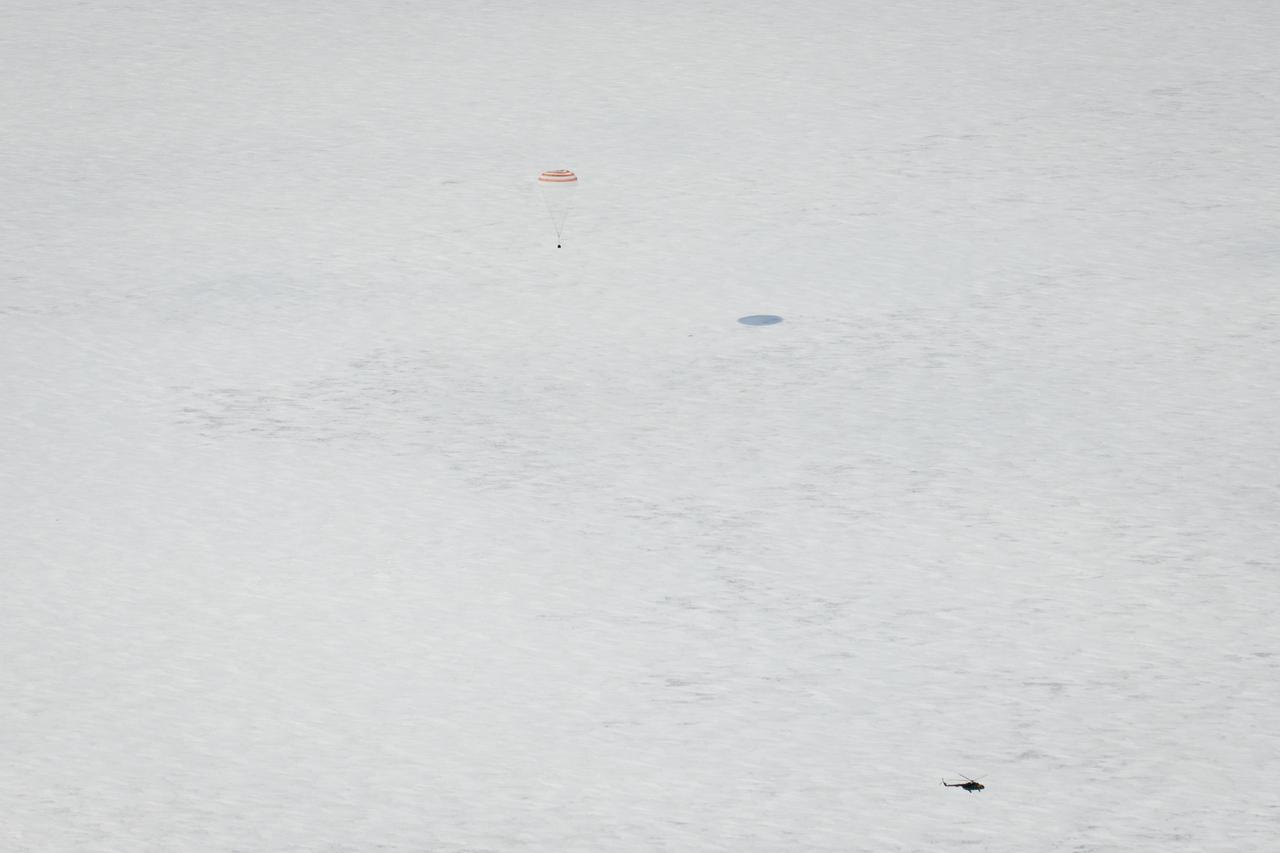A Russian Search and Rescue helicopter arrives as the Soyuz TMA-01M spacecraft lands with Expedition 26 Commander Scott Kelly and Flight Engineers Oleg Skripochka and Alexander Kaleri near the town of Arkalyk, Kazakhstan on Wednesday, March 16, 2011. NASA Astronaut Kelly, Russian Cosmonauts Skripochka and Kaleri are returning from almost six months onboard the International Space Station where they served as members of the Expedition 25 and 26 crews. Photo Credit: (NASA/Bill Ingalls)