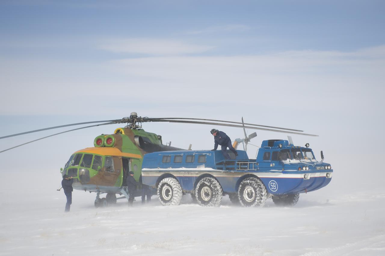 A Russian all terrain vehicle (ATV) takes Expedition 26 Commander Scott Kelly to a helicopter from the Soyuz TMA-01M spacecraft shortly after the capsule landed with Kelly and Expedition 26 Flight Engineers Oleg Skripochka and Alexander Kaleri near the town of Arkalyk, Kazakhstan on Wednesday, March 16, 2011. NASA Astronaut Kelly, Russian Cosmonauts Skripochka and Kaleri are returning from almost six months onboard the International Space Station where they served as members of the Expedition 25 and 26 crews. Photo Credit: (NASA/Bill Ingalls)