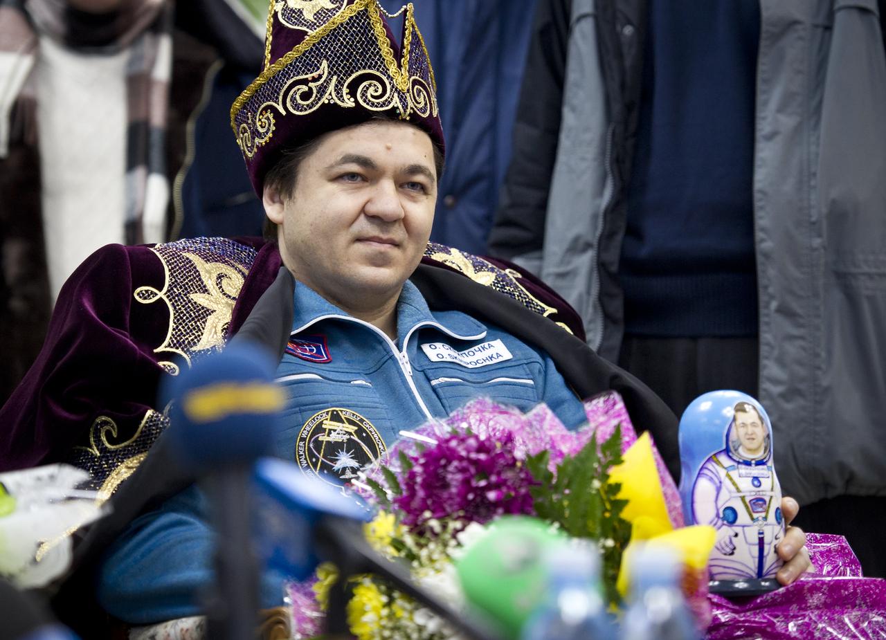 Expedition 26 Flight Engineer Oleg Skripochka listens to reporters questions in traditional Kazakh dress at the Kustanay, Kazakhstan airport on Wednesday, March 16, 2011 after he and fellow crew members Scott Kelly and Alexander Kaleri landed in their Soyuz TMA-01M capsule near the town of Arkalyk, Kazakhstan. NASA Astronaut Kelly, Russian Cosmonauts Skripochka and Kaleri are returning from almost six months onboard the International Space Station where they served as members of the Expedition 25 and 26 crews. Photo Credit: (NASA/Bill Ingalls)