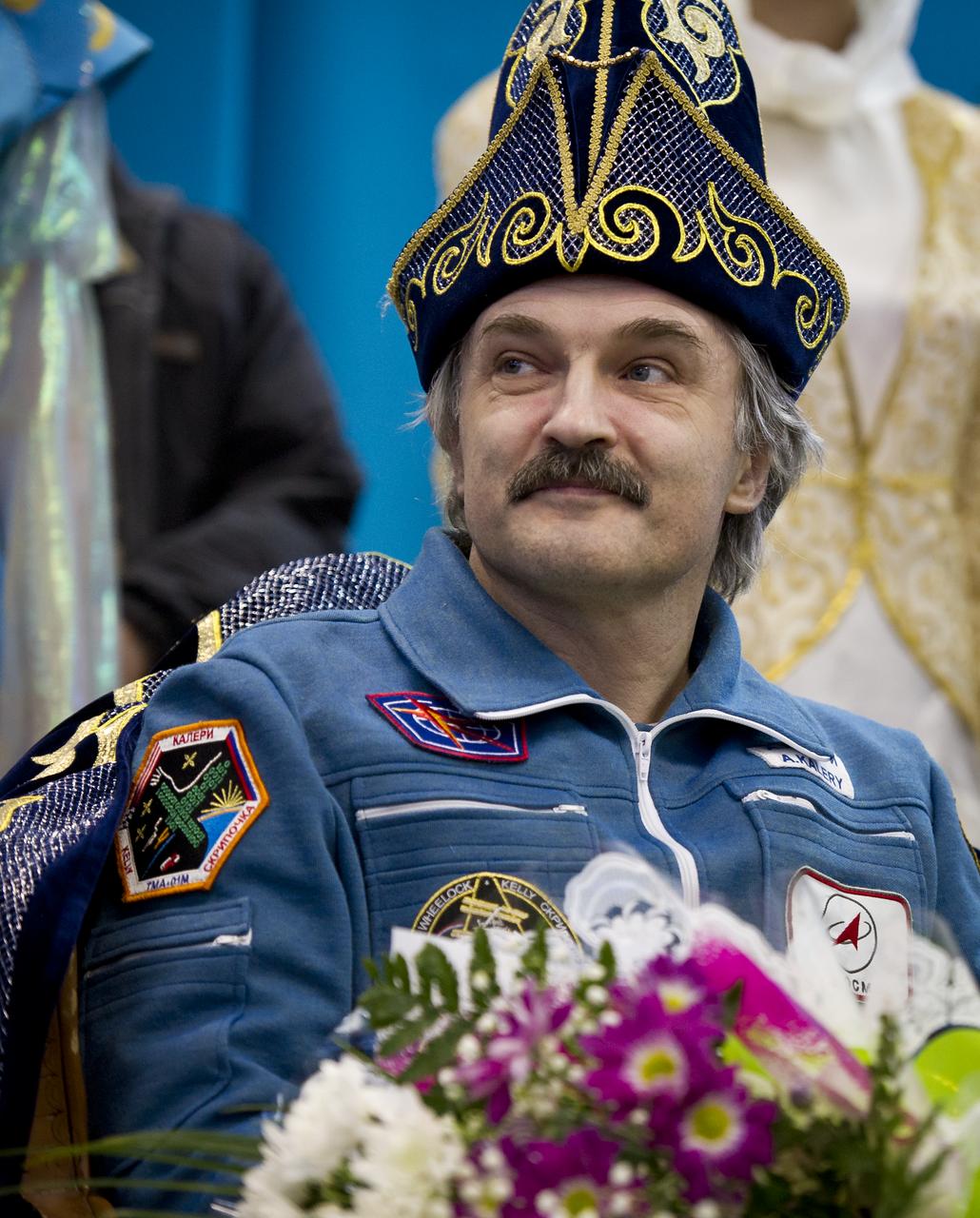 Expedition 26 Flight Engineer Alexander Kaleri listens to reporters questions while wearing a traditional Kazakh hat at the Kustanay, Kazakhstan airport on Wednesday, March 16, 2011 after he and fellow crew members Scott Kelly and Oleg Skripochka landed in their Soyuz TMA-01M capsule near the town of Arkalyk, Kazakhstan. NASA Astronaut Kelly, Russian Cosmonauts Skripochka and Kaleri are returning from almost six months onboard the International Space Station where they served as members of the Expedition 25 and 26 crews. Photo Credit: (NASA/Bill Ingalls)