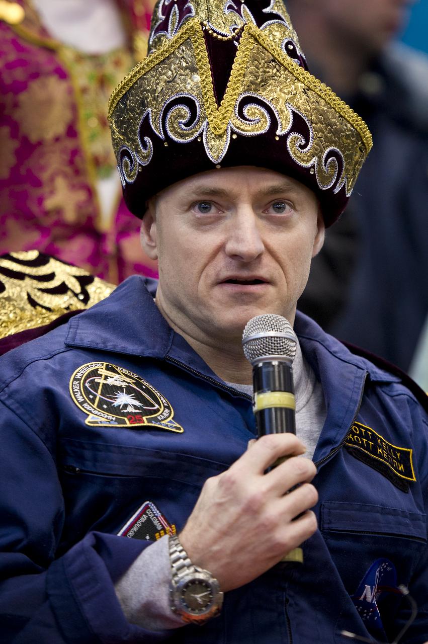 Expedition 26 Commander Scott Kelly listens to reporters questions while wearing a traditional Kazakh hat at the Kustanay, Kazakhstan airport on Wednesday, March 16, 2011 after he and fellow crew members Alexander Kaleri and Oleg Skripochka landed in their Soyuz TMA-01M capsule near the town of Arkalyk, Kazakhstan. NASA Astronaut Kelly, Russian Cosmonauts Skripochka and Kaleri are returning from almost six months onboard the International Space Station where they served as members of the Expedition 25 and 26 crews. Photo Credit: (NASA/Bill Ingalls)