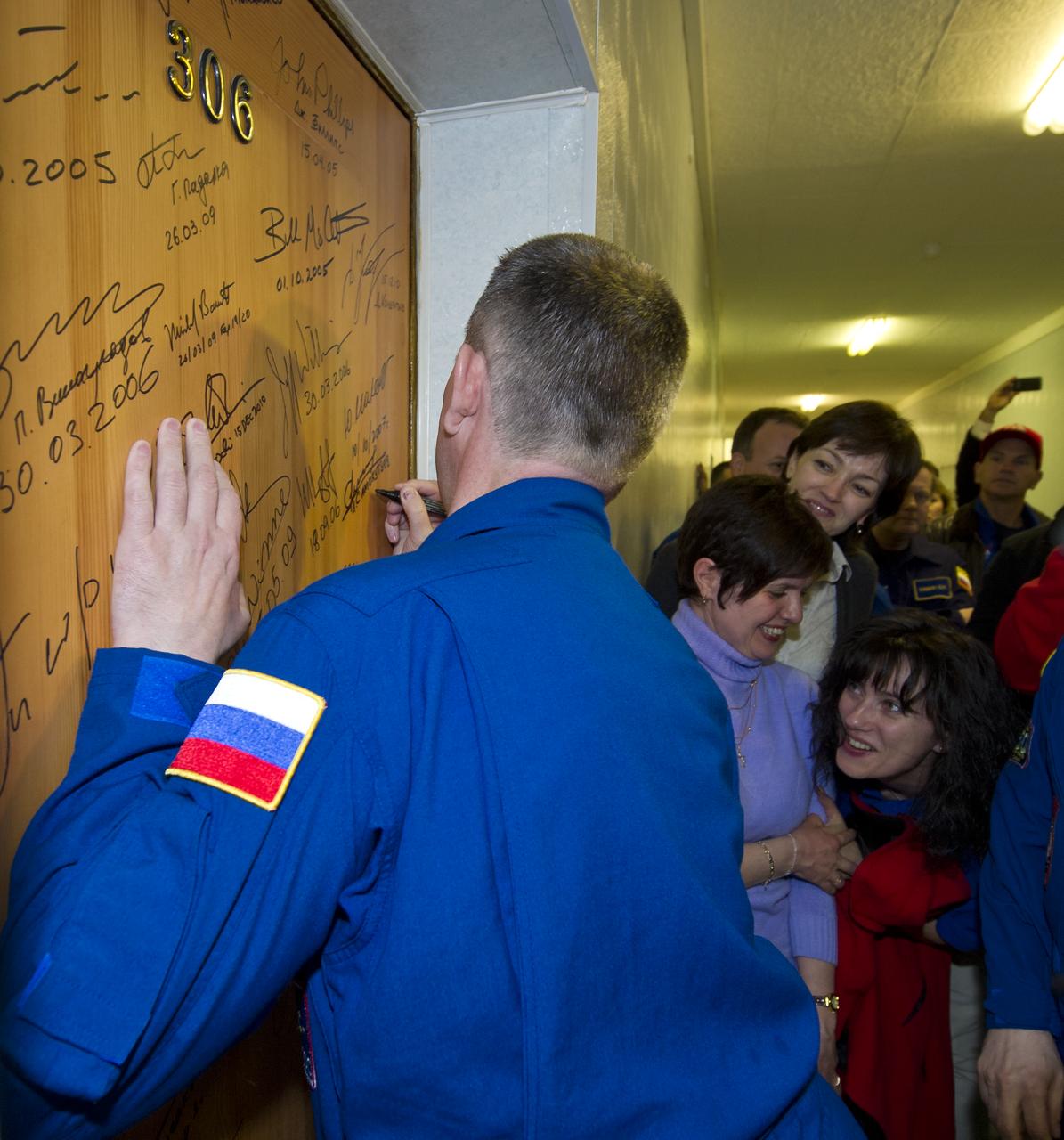 Expedition 27 Soyuz Commander Alexander Samokutyaev performs the traditional door signing Monday, April 4, 2011 at the Cosmonaut Hotel in Baikonur, Kazakhstan. Samokutyaev was launched onboard the Soyuz rocket the following morning with Expedition 27 NASA Flight Engineer Ron Garan and Russian Flight Engineer Andrey Borisenko on a mission to the International Space Station (ISS).  Photo Credit: (NASA/Carla Cioffi) 