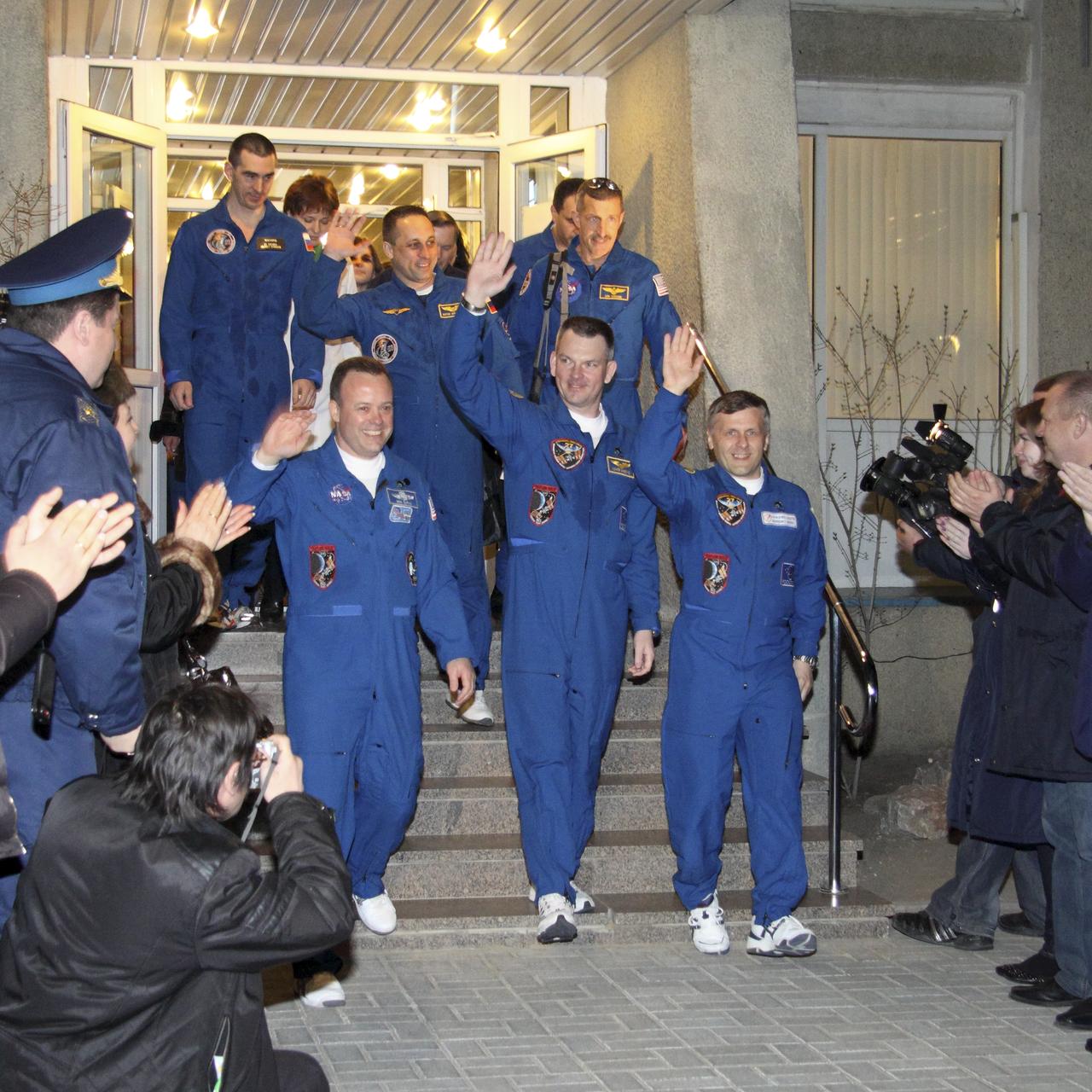 Expedition 27 NASA Flight Engineer Ron Garan, left, Expedition 27 Soyuz Commander Alexander Samokutyaev and Expedition 27 Flight Engineer Andrey Borisenko, third from left, depart the Cosmonaut Hotel on the evening before their Soyuz launch to the International Space Station Monday, April 4, 2011 in Baikonur, Kazakhstan.  The Soyuz, which has been dubbed “Gagarin”, is launching one week shy of the 50th anniversary of the launch of Yuri Gagarin from the same launch pad in Baikonur on April 12, 1961 to become the first human to fly in space.  Photo Credit: (NASA/Victor Zelentsov)
