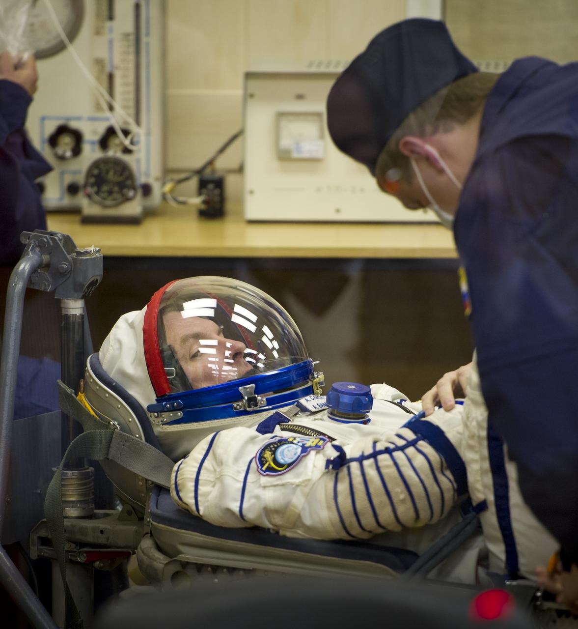 Expedition 27 Soyuz Commander Alexander Samokutyaev has his Russian Sokol suit prepared for launch by a technician at the Baikonur Cosmodrome in Baikonur, Kazakhstan, Tuesday, April 5, 2011. Samokutyaev, NASA Flight Engineer Ron Garan and Russian Flight Engineer Andrey Borisenko launched in their Soyuz TMA-21 rocket from the Baikonur Cosmodrome in Kazakhstan at 4:18 a.m. local time. (Photo Credit: NASA/Carla Cioffi)