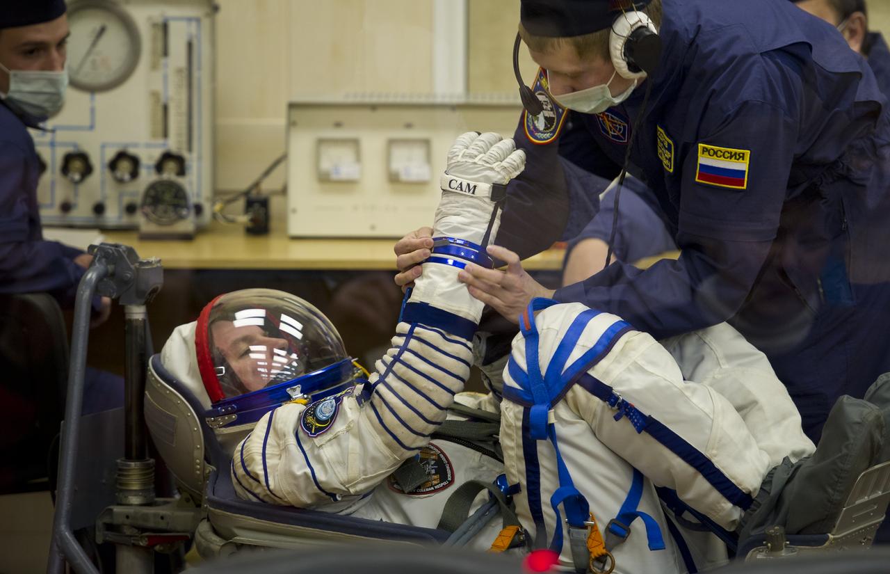 Expedition 27 Soyuz Commander Alexander Samokutyaev has his Russian Sokol suit prepared for launch by a technician at the Baikonur Cosmodrome in Baikonur, Kazakhstan, Tuesday, April 5, 2011. Samokutyaev, NASA Flight Engineer Ron Garan and Russian Flight Engineer Andrey Borisenko launched in their Soyuz TMA-21 rocket from the Baikonur Cosmodrome in Kazakhstan at 4:18 a.m. local time. (Photo Credit: NASA/Carla Cioffi)