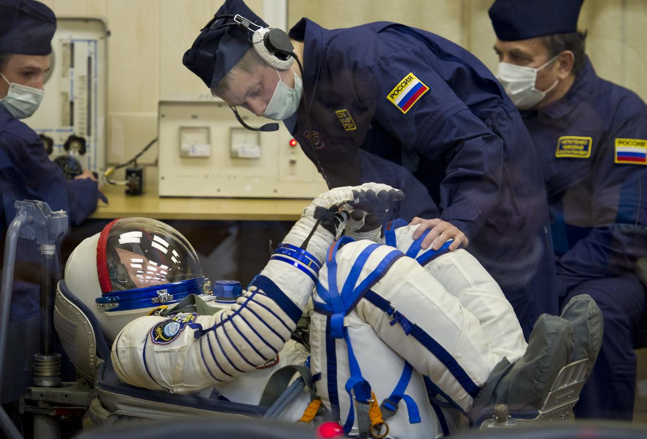 Expedition 27 Soyuz Commander Alexander Samokutyaev has his Russian Sokol suit prepared for launch by a technician at the Baikonur Cosmodrome in Baikonur, Kazakhstan, Tuesday, April 5, 2011. Samokutyaev, NASA Flight Engineer Ron Garan and Russian Flight Engineer Andrey Borisenko launched in their Soyuz TMA-21 rocket from the Baikonur Cosmodrome in Kazakhstan at 4:18 a.m. local time. (Photo Credit: NASA/Carla Cioffi)