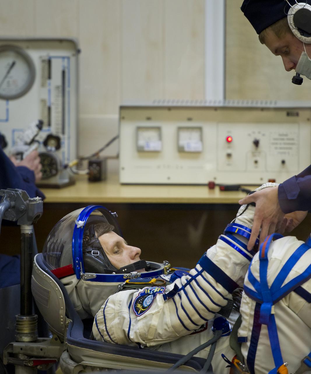 Expedition 27 Russian Flight Engineer Andrey Borisenko has his Russian Sokol suit prepared for launch by a technician at the Baikonur Cosmodrome in Baikonur, Kazakhstan, Tuesday, April 5, 2011. Borisenko, Soyuz Commander Alexander Samokutyaev and NASA Flight Engineer Ron Garan launched in their Soyuz TMA-21 rocket from the Baikonur Cosmodrome in Kazakhstan at 4:18 a.m. local time. (Photo Credit: NASA/Carla Cioffi)