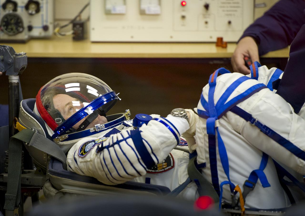 Expedition 27 NASA Flight Engineer Ron Garan has his Russian Sokol suit prepared for launch by a technician at the Baikonur Cosmodrome in Baikonur, Kazakhstan, Tuesday, April 5, 2011. Garan, Soyuz Commander Alexander Samokutyaev and Russian Flight Engineer Andrey Borisenko launched in their Soyuz TMA-21 rocket from the Baikonur Cosmodrome in Kazakhstan at 4:18 a.m. local time. (Photo Credit: NASA/Carla Cioffi)