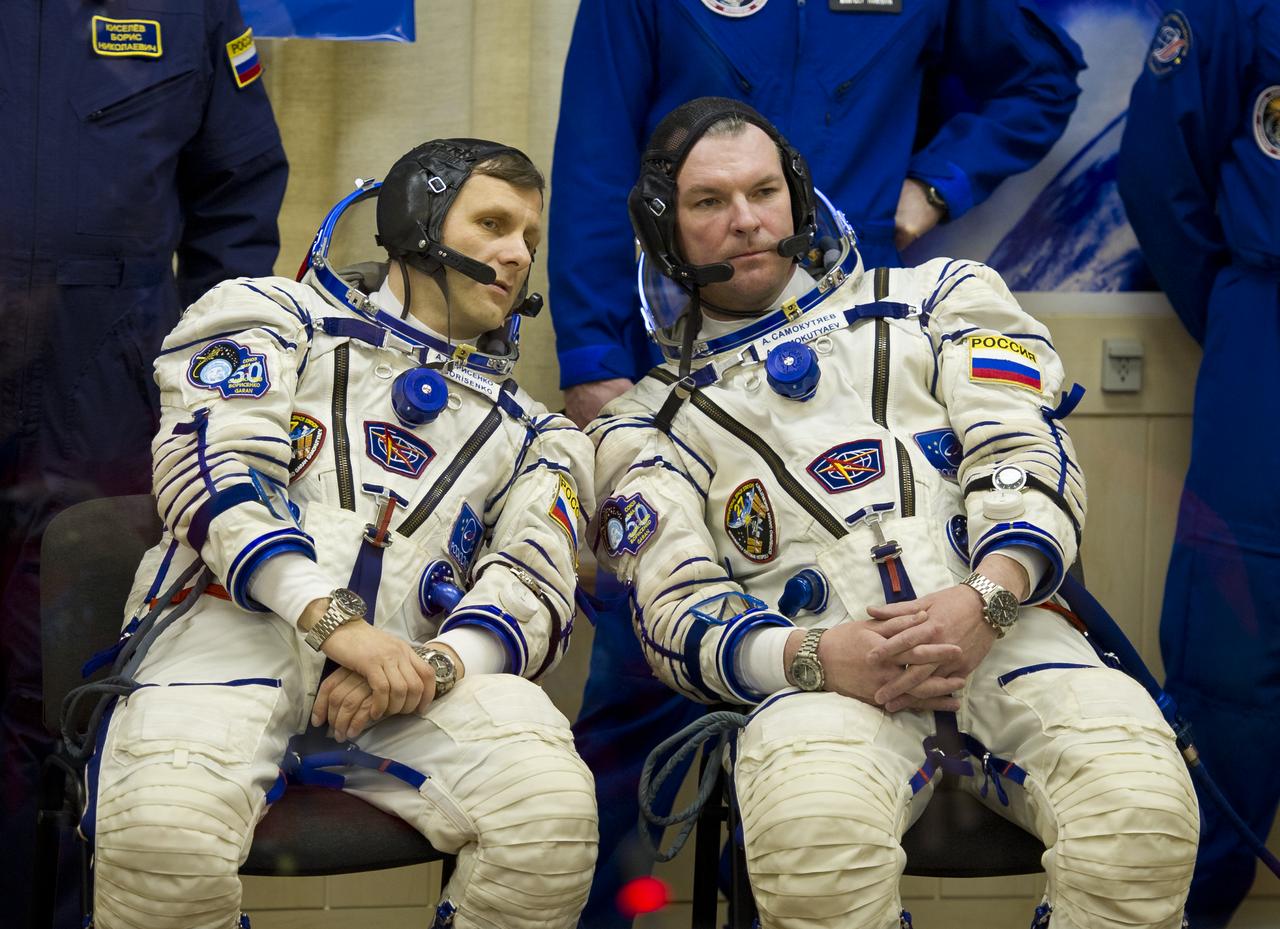 Expedition 27 Russian Flight Engineer Andrey Borisenko, left, and Soyuz Commander Alexander Samokutyaev have a word after having their Russian Sokol suits prepared for launch on the morning of Tuesday, April 5, 2011 at the Baikonur Cosmodrome in Kazakhstan. Photo Credit: (NASA/Carla Cioffi)