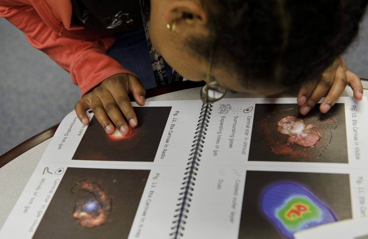 A student from the Maryland School For the Blind explores a braille map during NASA's Disability Mentoring Day, Thursday, April 7, 2011, at NASA Headquarters in Washignton. Photo Credit: (NASA/Paul E. Alers)