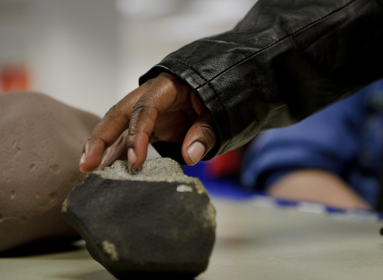 A student from the Maryland School For the Blind explores an object while learning about Meteorites, Asteroids and Comets during NASA's Disability Mentoring Day, Thursday, April 7, 2011, at NASA Headquarters in Washignton. Photo Credit: (NASA/Paul E. Alers)