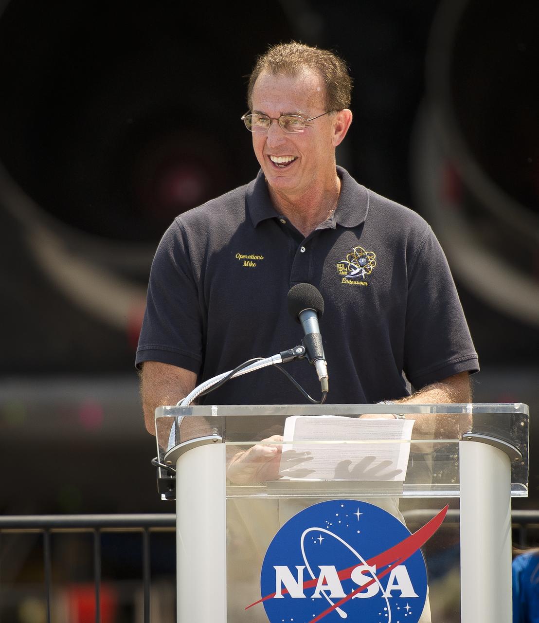 Endeavour Vehicle Manager for United Space Alliance Mike Parrish speaks at an event where NASA Administrator Charles Bolden announced where four space shuttle orbiters will be permanently displayed at the conclusion of the Space Shuttle Program, Tuesday, April 12, 2011, at Kennedy Space Center in Cape Canaveral, Fla. The four orbiters, Enterprise, which currently is on display at the Smithsonian's Steven F. Udvar-Hazy Center near Washington Dulles International Airport, will move to the Intrepid Sea, Air & Space Museum in New York, Discovery will move to Udvar-Hazy, Endeavour will be displayed at the California Science Center in Los Angeles and Atlantis, in background, will be displayed at the Kennedy Space Center Visitor’s Complex.  Photo Credit: (NASA/Bill Ingalls)