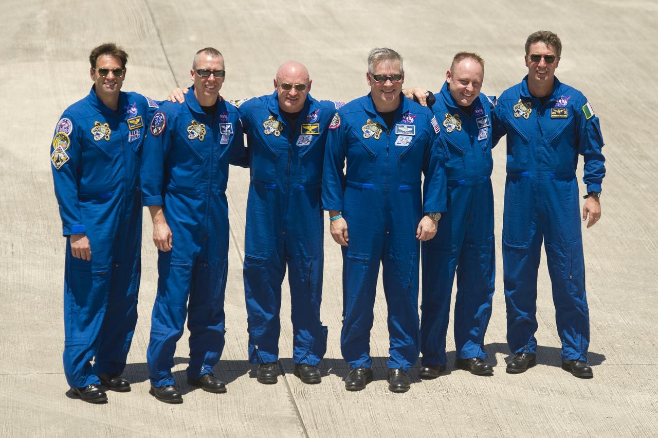 STS-134 Commander Mark Kelly, center, along with his crew pose for a photograph following their arrival to Kennedy Space Center, Tuesday, April 26, 2011, in Cape Canaveral, Fla. From left are Mission Specialists Greg Chamitoff, Andrew Feustel, Kelly, Pilot Greg H. Johnson, Mission Specialist Mike Fincke and European Space Agency astronaut Roberto Vittori. The six astronauts for space shuttle Endeavour's STS-134 mission to the International Space Station arrived at Kennedy's Shuttle Landing Facility (SLF) in T-38 jets early Tuesday afternoon. Photo Credit: (NASA/Bill Ingalls)