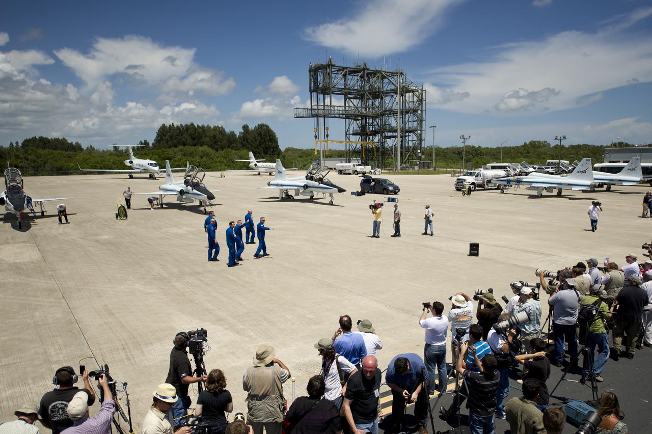 STS-134 crew members, Commander Mark Kelly, Mission Specialists Greg Chamitoff, Andrew Feustel, Pilot Greg H. Johnson, Mission Specialist Mike Fincke and European Space Agency astronaut Roberto Vittori wave following their arrival to Kennedy Space Center, Tuesday, April 26, 2011, in Cape Canaveral, Fla. The six astronauts for space shuttle Endeavour's STS-134 mission to the International Space Station arrived at Kennedy's Shuttle Landing Facility (SLF) in T-38 jets early Tuesday afternoon. Photo Credit: (NASA/Bill Ingalls)
