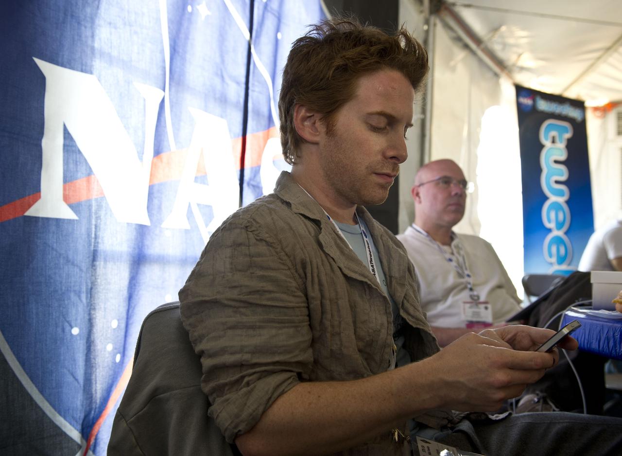 Actor Seth Green, a NASA Twitter follower, tweets from his device during the STS-134 Tweetup, Thursday, April 28, 2011, at Kennedy Space Center in Cape Canaveral, Fla. About 150 NASA Twitter followers attended the event. Photo Credit: (NASA/Paul E. Alers)