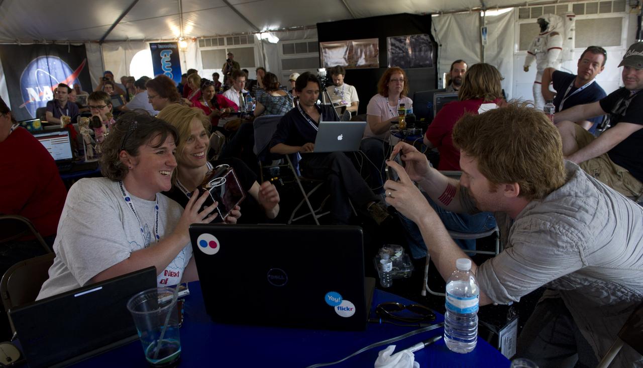 Actor Seth Green, right, takes a quick photo of two NASA Tweeps holding a Golden Orb Spider during the STS-134 Tweetup, Thursday, April 28, 2011, at Kennedy Space Center in Cape Canaveral, Fla. About 150 NASA Twitter followers attended the event. Photo Credit: (NASA/Paul E. Alers)