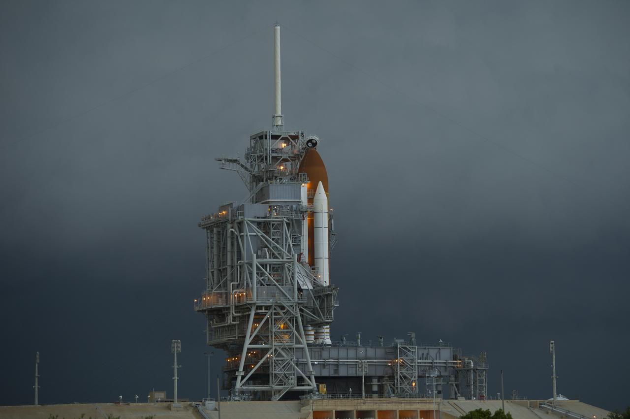 The space shuttle Endeavour is seen on launch pad 39a as a storm passes by prior to the rollback of the Rotating Service Structure (RSS), Thursday, April 28, 2011, at Kennedy Space Center in Cape Canaveral, Fla. During the 14-day mission, Endeavour and the STS-134 crew will deliver the Alpha Magnetic Spectrometer (AMS) and spare parts including two S-band communications antennas, a high-pressure gas tank and additional spare parts for Dextre. Launch is targeted for Friday, April 29 at 3:47 p.m. EDT.  Photo credit: (NASA/Bill Ingalls)
