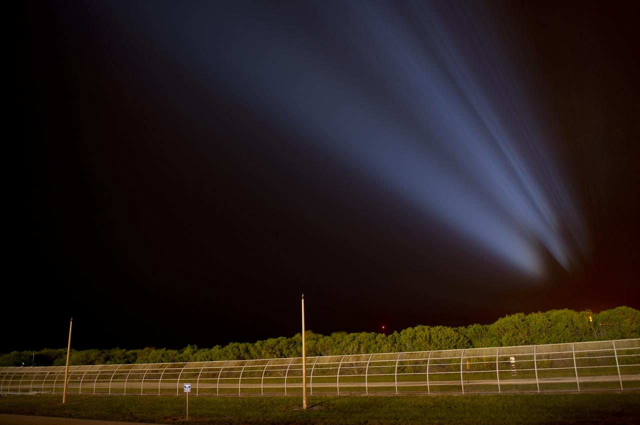 An faint profile outline of the space shuttle Endeavour is seen projected in the sky as powerful xenon lights illuminate launch pad 39a shortly after the rollback of the Rotating Service Structure (RSS) from Endeavour, Thursday, April 28, 2011, at Kennedy Space Center in Cape Canaveral, Fla. During the 14-day mission, Endeavour and the STS-134 crew will deliver the Alpha Magnetic Spectrometer (AMS) and spare parts including two S-band communications antennas, a high-pressure gas tank and additional spare parts for Dextre. Launch is targeted for Friday, April 29 at 3:47 p.m. EDT.  Photo credit: (NASA/Bill Ingalls)