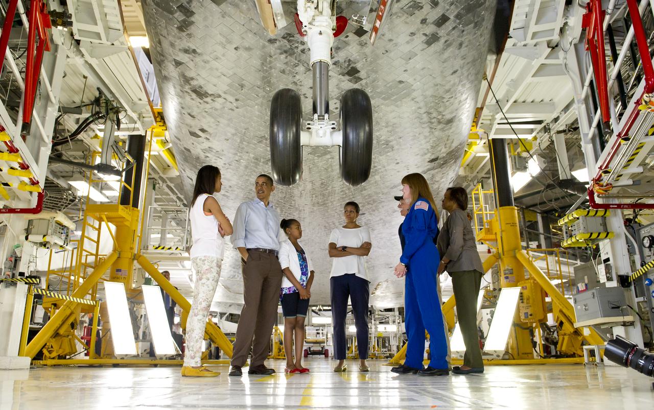 President Barack Obama, First Lady Michelle Obama, daughters Malia, left, Sasha, Marian Robinson, Astronaut Janet Kavandi and United Space Alliance project lead for thermal protection systems Terry White, walk under the landing gear of the space shuttle Atlantis as they visit Kennedy Space Center in Cape Canaveral, Fla., Friday, April 29, 2011. Photo Credit: (NASA/Bill Ingalls)