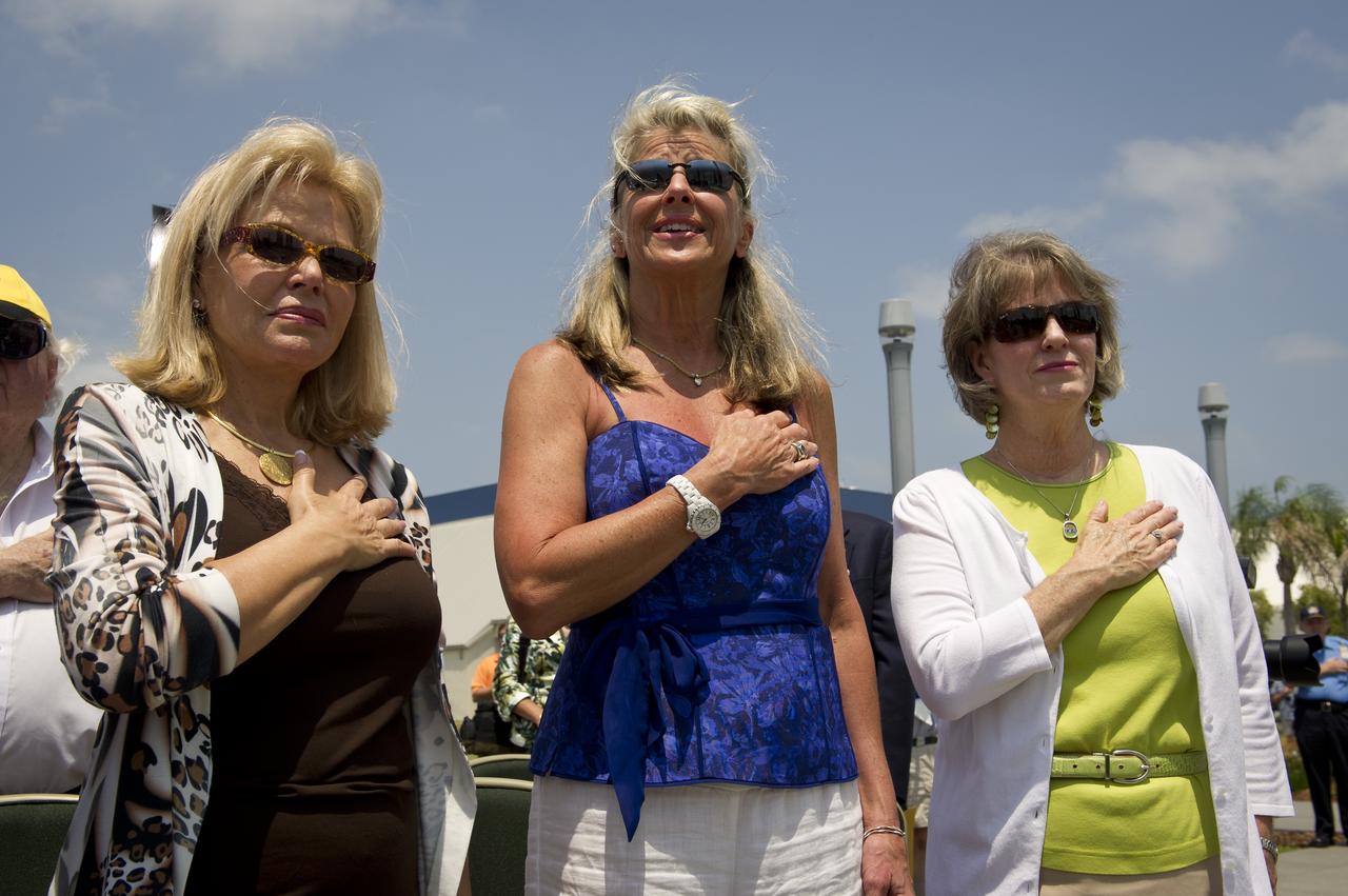 Patty Carpenter, wife of NASA Mercury Astronaut Scott Carpenter, left, Daughters of NASA astronaut Alan Shepard, Laura Shepard Churchley, and, Alice Wackermann, right, sing the National Anthem during an unveiling ceremony of two USPS stamps that commemorate and celebrate 50 years of US Spaceflight and the MESSENGER program during an event, Wednesday, May 4, 2011 at the NASA Kennedy Space Center in Cape Canaveral, Fla.  One stamp commemorates NASA’s Project Mercury, America’s first manned spaceflight program, and NASA astronaut Alan Shepard’s historic flight on May 5, 1961, aboard spacecraft Freedom 7.  The other stamp draws attention to NASA’s unmanned MESSENGER mission, a scientific investigation of the planet Mercury. On March 17, 2011, MESSENGER became the first spacecraft to enter into orbit around Mercury. Photo Credit: (NASA/Bill Ingalls)