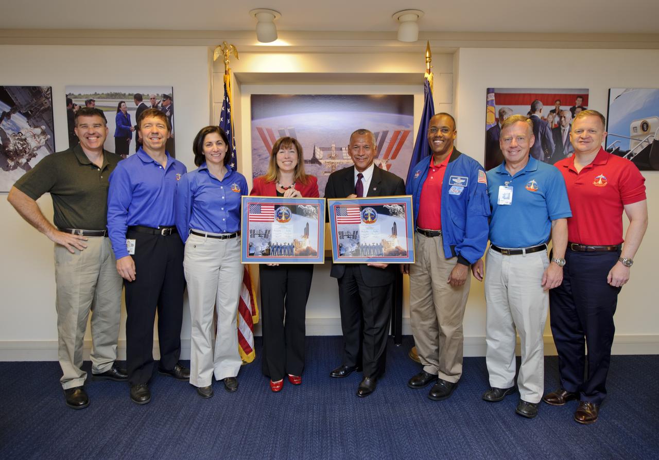 NASA Administrator Charles Bolden along with Deputy Administrator Lori Garver, center, stands with STS-133 crew members from left, Mission Specialists Stephen Bowen, Michael Barratt, Nicole Slott, Alvin Drew, Commander Steve Lindsey, and Pilot Eric Boe after being presented montages, Monday, May 9, 2011, at NASA Headquarters in Washington. Photo Credit: (NASA/Paul E. Alers)