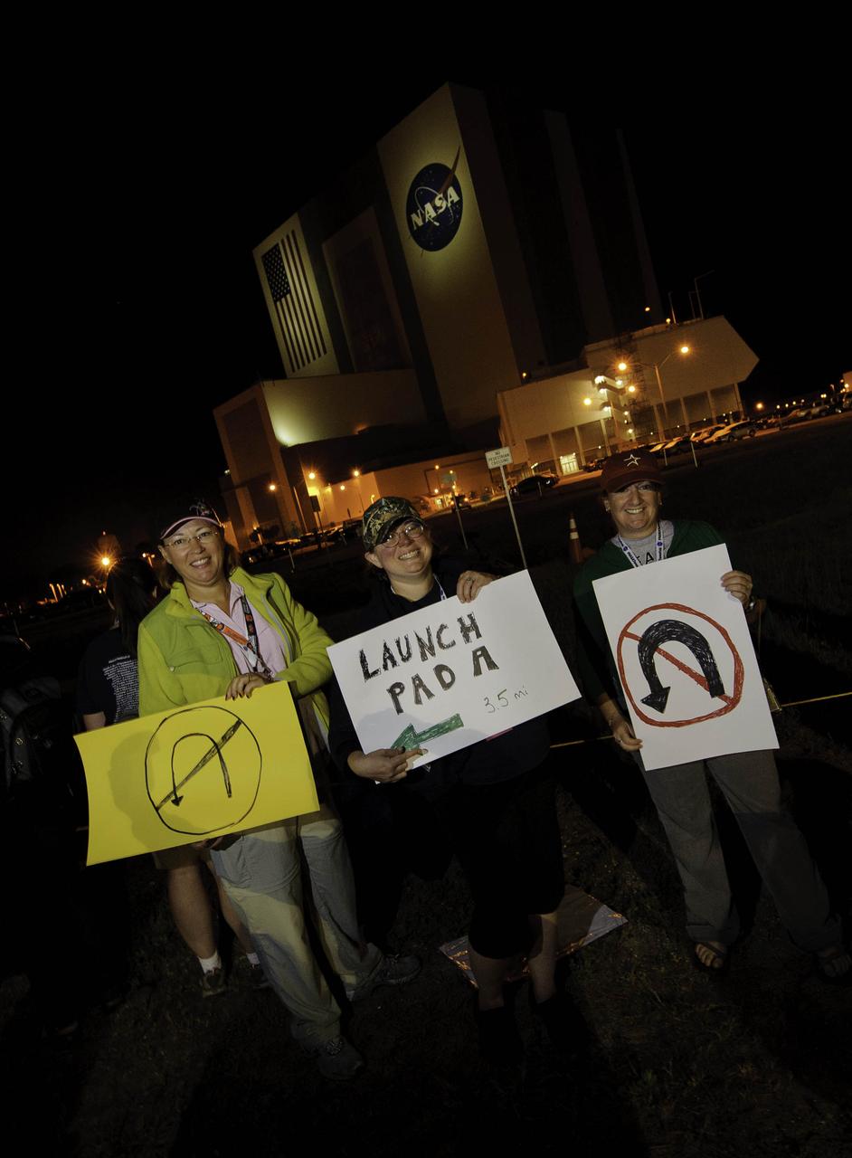 NASA Twitter followers from left; Leigh Checkman (@liprap), Barbara Nixon (@BarbaraNixon), and Beth Schaefer (@boonbeth), hold up signs just before the Astrovan, carrying the STS-134 crew out to launch pad 39a passed by, early Monday, May 16, 2011, at Kennedy Space Center in Cape Canaveral, Fla. During the 16-day mission, Endeavour, with Commander Mark Kelly, Pilot Gregory H. Johnson, Mission Specialists Michael Fincke, Greg Chamitoff, Andrew Feustel and European Space Agency astronaut Robert Vittori will deliver the Alpha Magnetic Spectrometer (AMS) and spare parts including two S-band communications antennas, a high-pressure gas tank and additional spare parts for Dextre. Photo Credit: (NASA/Paul E. Alers)