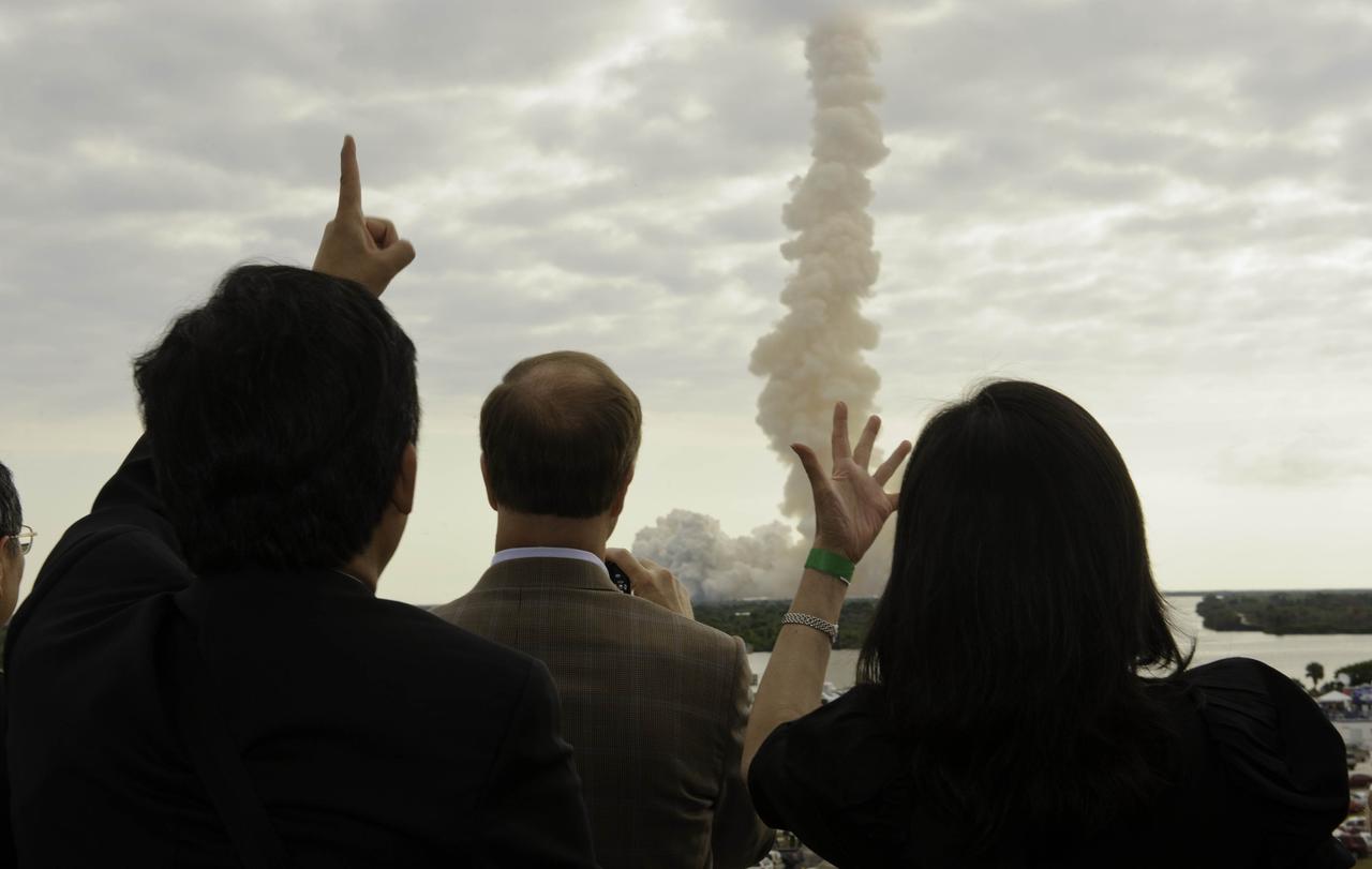 Guests view space shuttle Endeavour (STS-134) as it launches skyward from the balcony of the Operations Support Building II (OSB-II), Monday, May 16, 2011, at Kennedy Space Center in Cape Canaveral, Fla. During the 16-day mission, Endeavour, with Commander Mark Kelly, Pilot Gregory H. Johnson, Mission Specialists Michael Fincke, Greg Chamitoff, Andrew Feustel and European Space Agency astronaut Robert Vittori will deliver the Alpha Magnetic Spectrometer (AMS) and spare parts including two S-band communications antennas, a high-pressure gas tank and additional spare parts for Dextre. Photo Credit: (NASA/Paul E. Alers) 