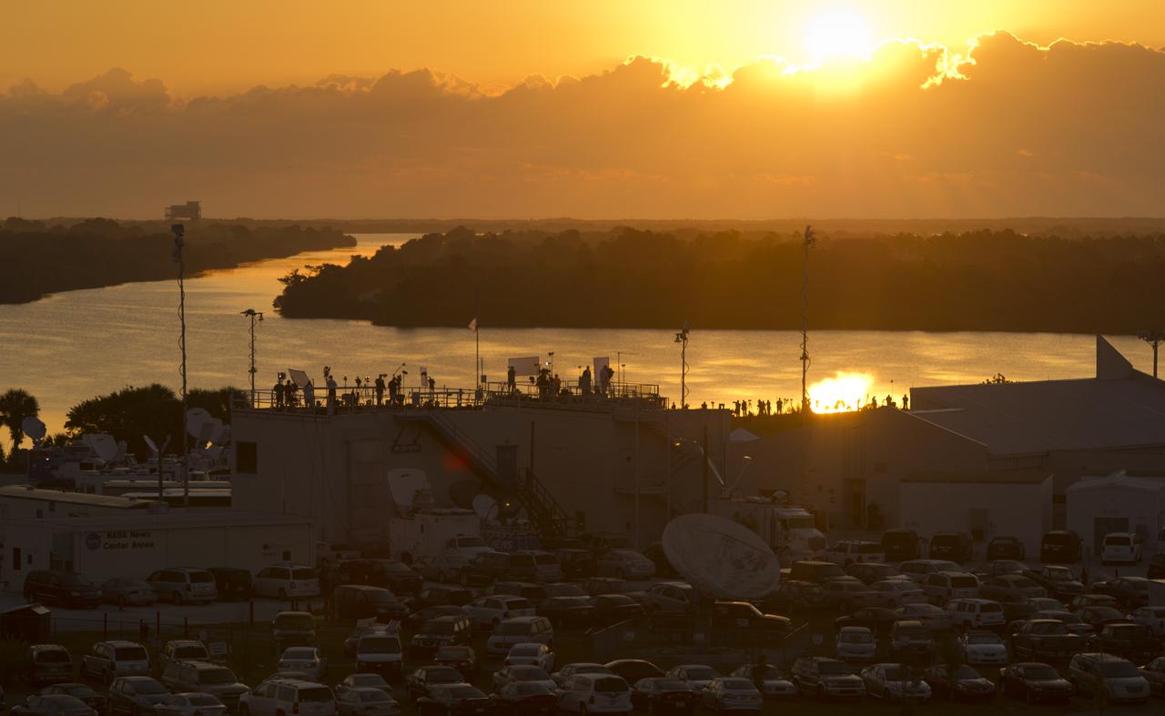 The press site at the NASA Kennedy Space Center is seen as the sun rises a few hours prior to the launch of the space shuttle Endeavour with the STS-134 crew, Monday, May 16, 2011, in Cape Canaveral, Fla.  During the mission, Endeavour and the STS-134 crew will deliver the Alpha Magnetic Spectrometer (AMS) and spare parts including two S-band communications antennas, a high-pressure gas tank and additional spare parts for Dextre. Photo Credit: (NASA/Bill Ingalls)
