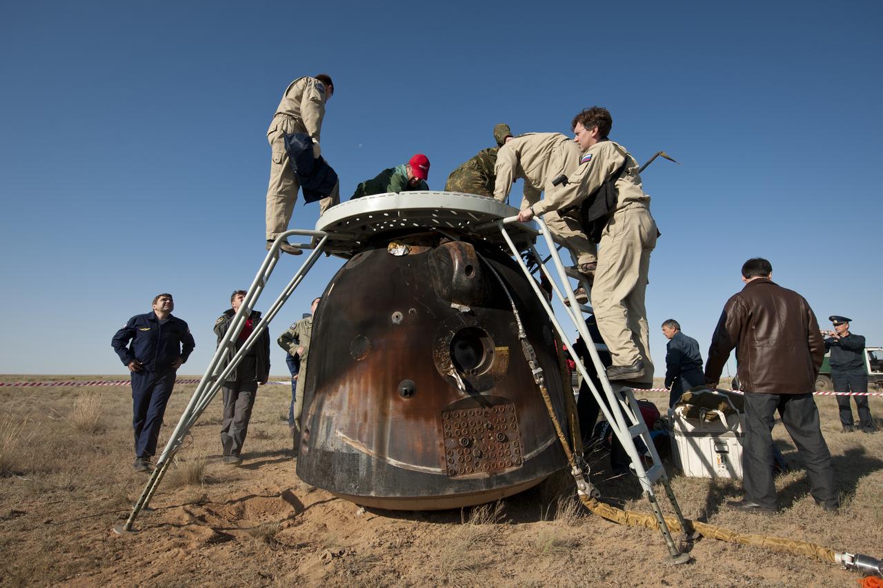 Russian support personnel work to help get crew members out of the Soyuz TMA-20 spacecraft shortly after the capsule landed with Expedition 27 Commander Dmitry Kondratyev and Flight Engineers Paolo Nespoli and Cady Coleman in a remote area southeast of the town of Zhezkazgan, Kazakhstan, on Tuesday, May 24, 2011. NASA Astronaut Coleman, Russian Cosmonaut Kondratyev and Italian Astronaut Nespoli are returning from more than five months onboard the International Space Station where they served as members of the Expedition 26 and 27 crews. Photo Credit: (NASA/Bill Ingalls)