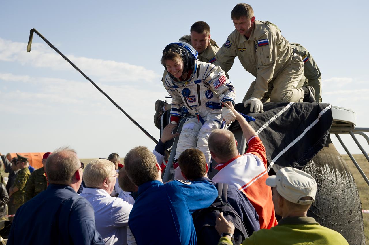 Expedition 27 Flight Engineer Cady Coleman is helped out of the Spyuz TMA-20 spacecraft shortly after she and Commander Dmitry Kondratyev and Paolo Nespoli landed southeast of the town of Zhezkazgan, Kazakhstan, on Tuesday, May 24, 2011. NASA Astronaut Coleman, Russian Cosmonaut Kondratyev and Italian Astronaut Nespoli are returning from more than five months onboard the International Space Station where they served as members of the Expedition 26 and 27 crews. Photo Credit: (NASA/Bill Ingalls)