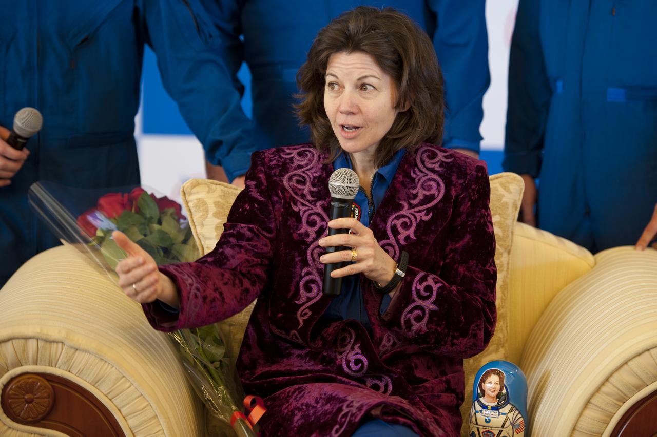 Expedition 27 Flight Engineer Cady Coleman answers reporters questions in traditional Kazakh dress during a press conference at the Karaganda airport shortly after she and Commander Dmitry Kondratyev and Flight Engineer Paolo Nespoli landed in their Soyuz TMA-20 southeast of the town of Zhezkazgan, Kazakhstan, on Tuesday, May 24, 2011. NASA Astronaut Coleman, Russian Cosmonaut Kondratyev and Italian Astronaut Nespoli are returning from more than five months onboard the International Space Station where they served as members of the Expedition 26 and 27 crews. Photo Credit: (NASA/Bill Ingalls)