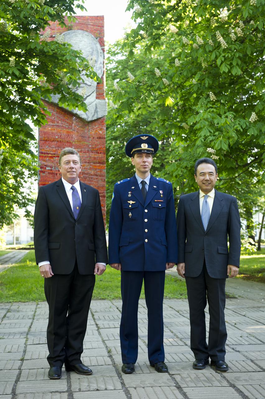 Expedition 28 crew members, Flight Engineer Mike Fossum, left, Soyuz commander Sergei Volkov, center, and Flight Engineer Satoshi Furukawa, pose for a photograph on the grounds of the Gagarin Cosmonaut Training Center, Wednesday, May 25, 2011 in Star City, Russia.  The crew later departed for Baikonur, Kazakhstan in preparation for their June launch onboard a Soyuz rocket.  Photo Credit: (NASA/Bill Ingalls)