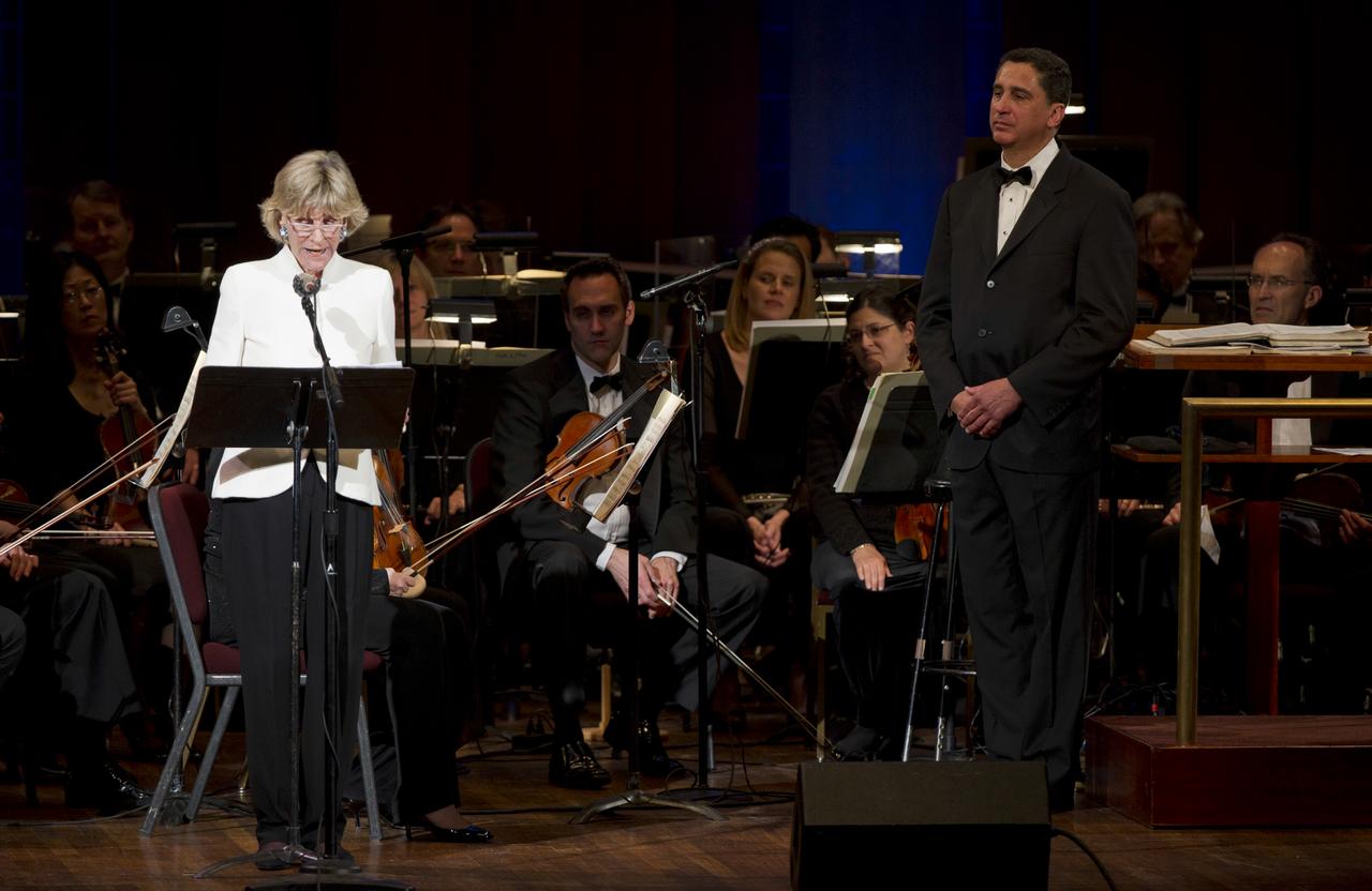 Jean Kennedy Smith, sister of John F. Kennedy, delivers remarks during a program entitled Human Spaceflight: The Kennedy Legacy as Emil de Cou, conductor of the Space Philharmonic, right, looks on, Wednesday, May 25, 2011, in the concert hall at the John F. Kennedy Center for the Performing Arts in Washington. The event marked the 50th Anniversary of President John F. Kennedy's Special Message to the Congress on Urgent National Needs in which he stated "landing a man on the moon and returning him safely to earth". Photo Credit: (NASA/Paul E. Alers)