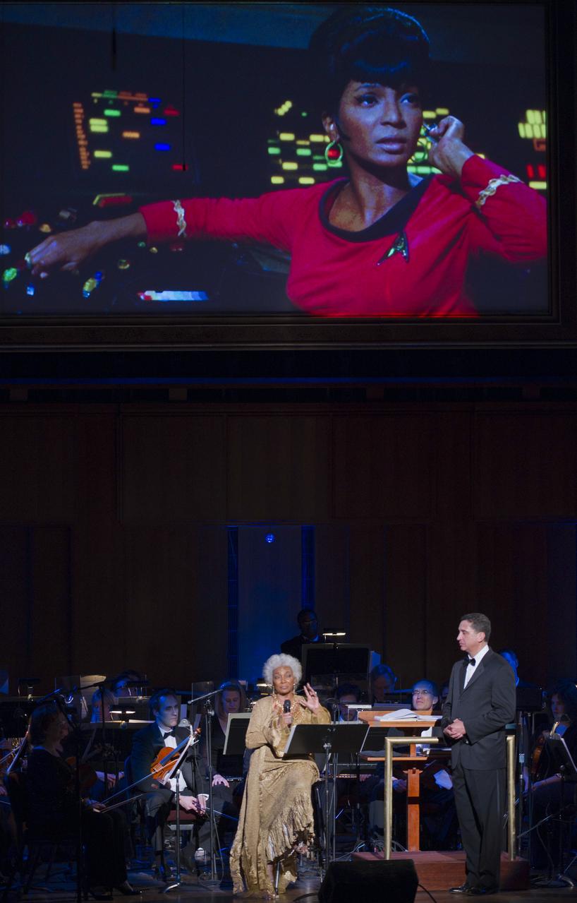 Actress Nichelle Nichols, best known for her role as communications officer Lieutenant Uhura in the series "Star Trek", speaks as Emil de Cou, right, looks on, Wednesday, May 25, 2011, in the concert hall at the John F. Kennedy Center for the Performing Arts in Washington. The event marked the 50th Anniversary of President John F. Kennedy's Special Message to the Congress on Urgent National Needs in which he stated "landing a man on the moon and returning him safely to earth". Photo Credit: (NASA/Paul E. Alers)