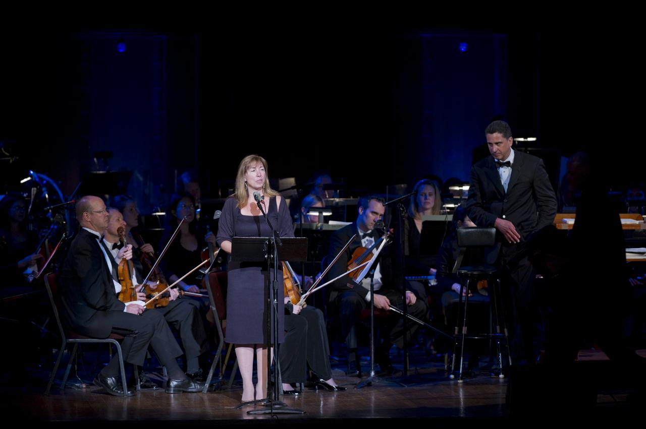 Deputy Administrator Lori Garver delivers remarks as Emil de Cou, right, looks on during a program commemorating Human Spaceflight and the Kennedy Legacy, Wednesday, May 25, 2011, in the concert hall at the John F. Kennedy Center for the Performing Arts in Washington. The event marked the 50th Anniversary of President John F. Kennedy's Special Message to the Congress on Urgent National Needs in which he stated "landing a man on the moon and returning him safely to earth". Photo Credit: (NASA/Paul E. Alers)