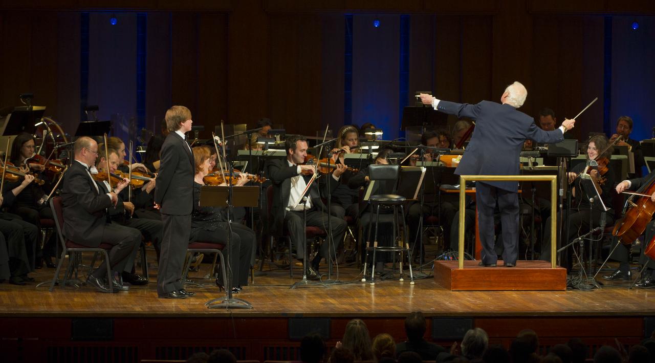 Former Apolo 11 astronaut Buzz Aldrin guest conducts the Space Philharmonic as Ted Kennedy III, left, looks on during a program commemorating Human Spaceflight and the Kennedy Legacy, Wednesday, May 25, 2011, in the concert hall at the John F. Kennedy Center for the Performing Arts in Washington. The event marked the 50th Anniversary of President John F. Kennedy's Special Message to the Congress on Urgent National Needs in which he stated "landing a man on the moon and returning him safely to earth". Photo Credit: (NASA/Paul E. Alers)