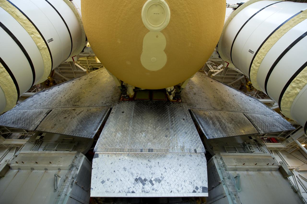 Space Shuttle Atlantis (STS-135) is seen atop a Mobile Launcher Platform (MLP) just prior to beginning its journey from High Bay 3 in the Vehicle Assembly Building to Launch Pad 39a for its final flight, Tuesday evening, May 31, 2011, at Kennedy Space Center in Cape Canaveral, Fla. The 3.4-mile trek, known as "rollout," will take about seven hours to complete. Atlantis will carry the Raffaello multipurpose logistics module to deliver supplies, logistics and spare parts to the International Space Station. The launch of STS-135 is targeted for July 8. Photo Credit: (NASA/Bill Ingalls)