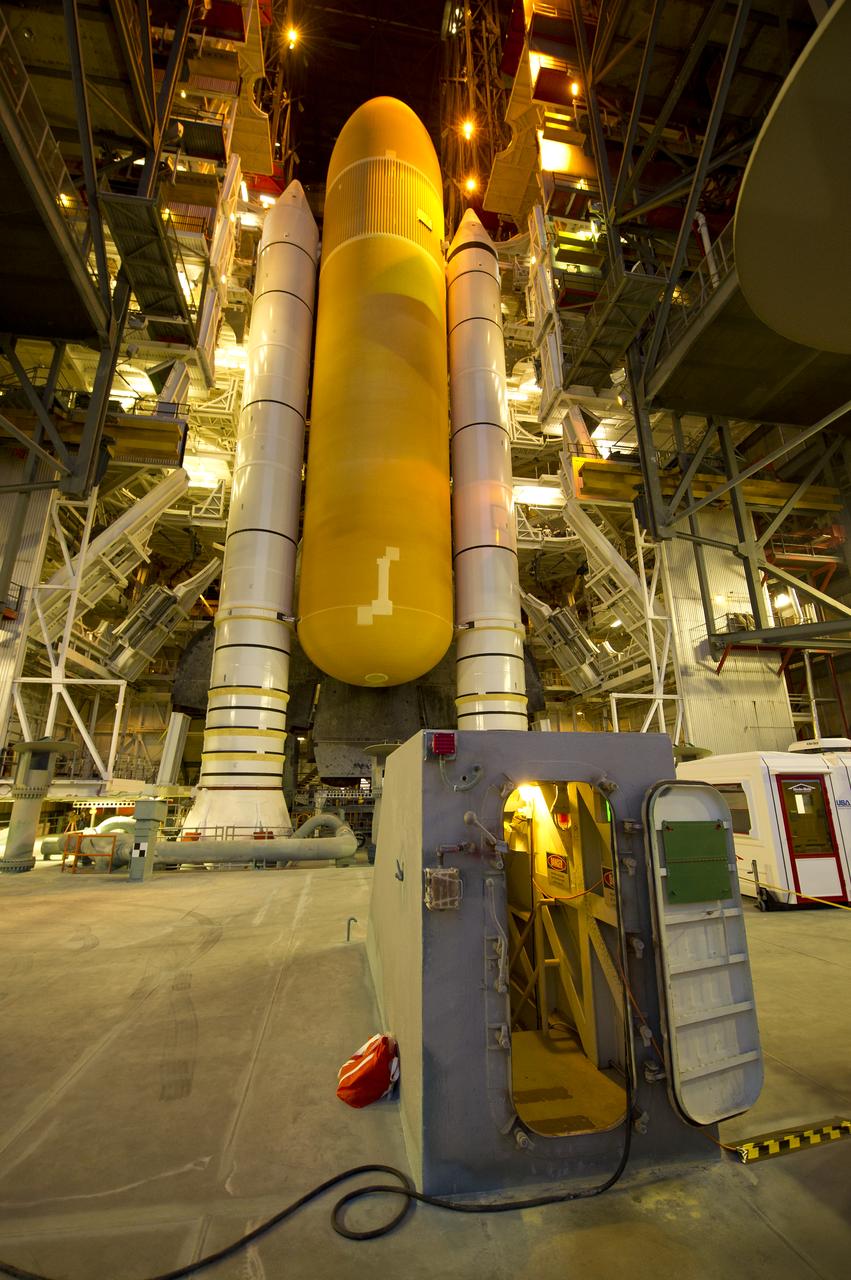 Space Shuttle Atlantis (STS-135) is seen atop a Mobile Launcher Platform (MLP) just prior to beginning its journey from High Bay 3 in the Vehicle Assembly Building to Launch Pad 39a for its final flight, Tuesday evening, May 31, 2011, at Kennedy Space Center in Cape Canaveral, Fla. The 3.4-mile trek, known as "rollout," will take about seven hours to complete. Atlantis will carry the Raffaello multipurpose logistics module to deliver supplies, logistics and spare parts to the International Space Station. The launch of STS-135 is targeted for July 8. Photo Credit: (NASA/Bill Ingalls)