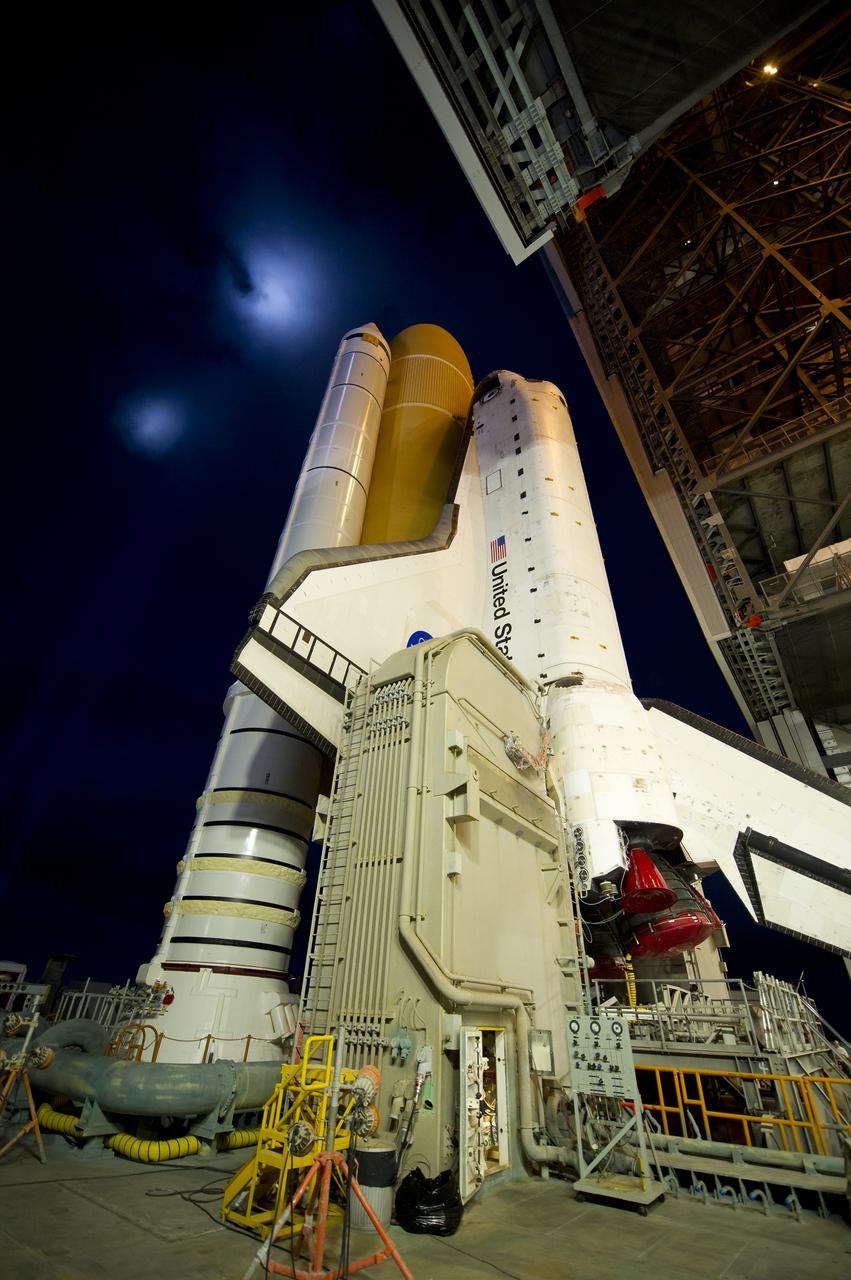 Space Shuttle Atlantis (STS-135) is seen atop the Mobile Launch Platform (MLP) as it begins its journey from High Bay 3 in the Vehicle Assembly Building to Launch Pad 39a for its final flight, Tuesday evening, May 31, 2011, at Kennedy Space Center in Cape Canaveral, Fla. The 3.4-mile trek, known as "rollout," will take about seven hours to complete. Atlantis will carry the Raffaello multipurpose logistics module to deliver supplies, logistics and spare parts to the International Space Station. The launch of STS-135 is targeted for July 8. Photo Credit: (NASA/Bill Ingalls)