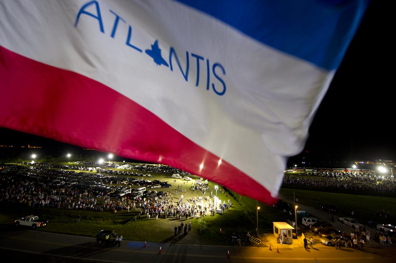 Crowds of people are seen watching the rollout of the space shuttle Atlantis in this image made atop of the Mobile Launcher Platform (MLP) that is carrying Atlantis from High Bay 3 in the Vehicle Assembly Building to Launch Pad 39a for its final flight, Tuesday evening, May 31, 2011, at Kennedy Space Center in Cape Canaveral, Fla. The 3.4-mile trek, known as "rollout," will take about seven hours to complete. Atlantis will carry the Raffaello multipurpose logistics module to deliver supplies, logistics and spare parts to the International Space Station. The launch of STS-135 is targeted for July 8. Photo Credit: (NASA/Bill Ingalls)